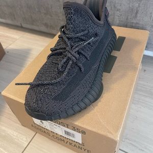 Yeezy black sneakers brand new with tags and box.